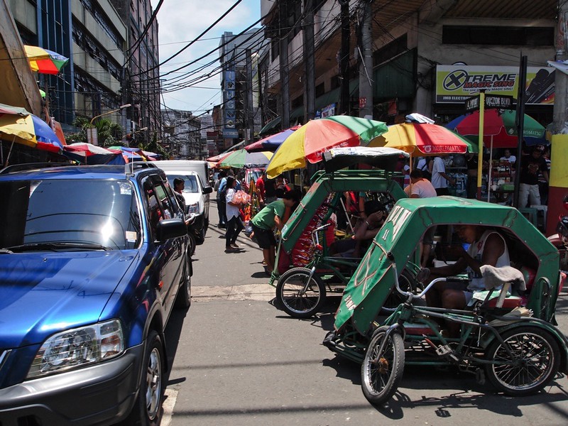 A person riding a motorcycle on a city street
Description automatically generated