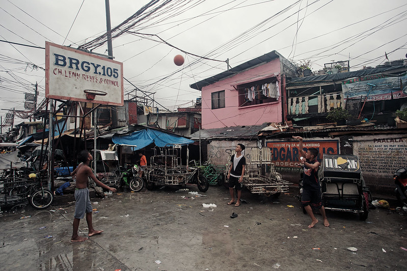 A group of people walking down a street
Description automatically generated